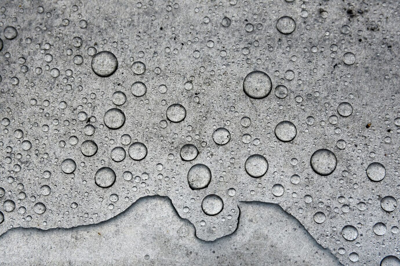Thin film of condensation on a bare concrete basement floor